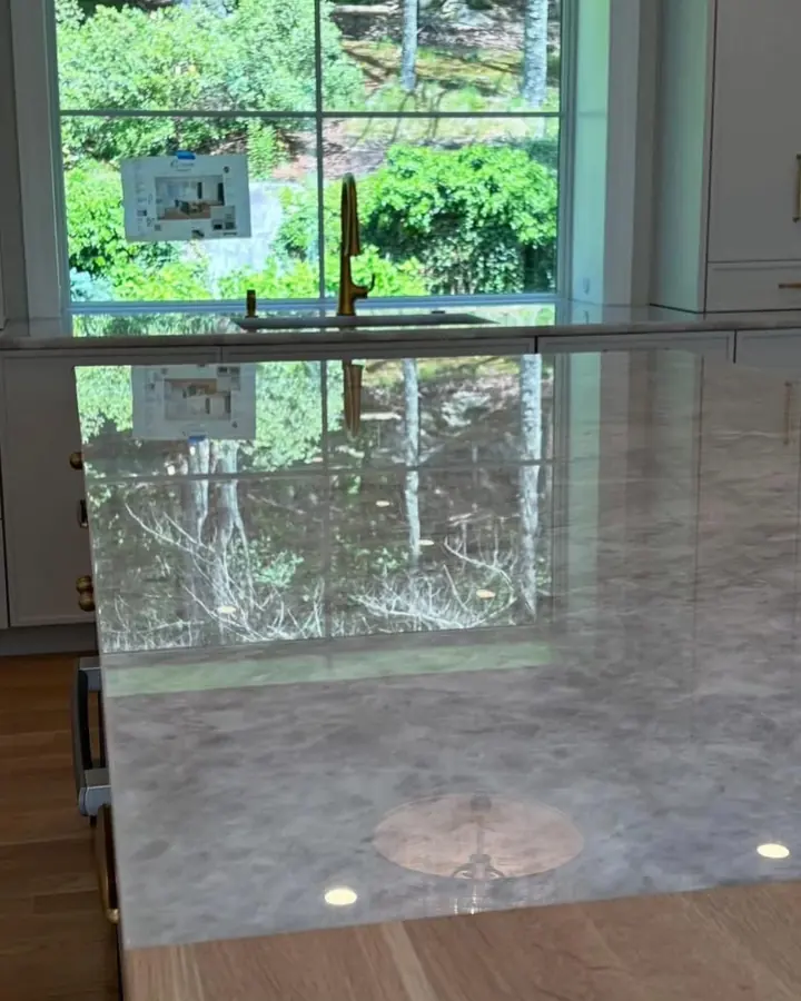 Polished Cristallo quartzite island reflecting the window behind it